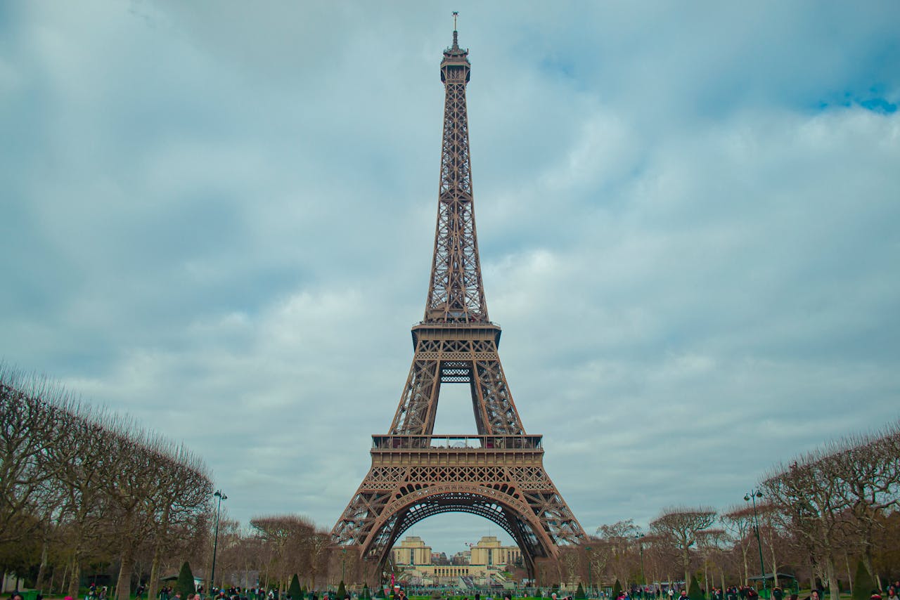 Low angle view of the Eiffel Tower against a cloudy sky in Paris, France.